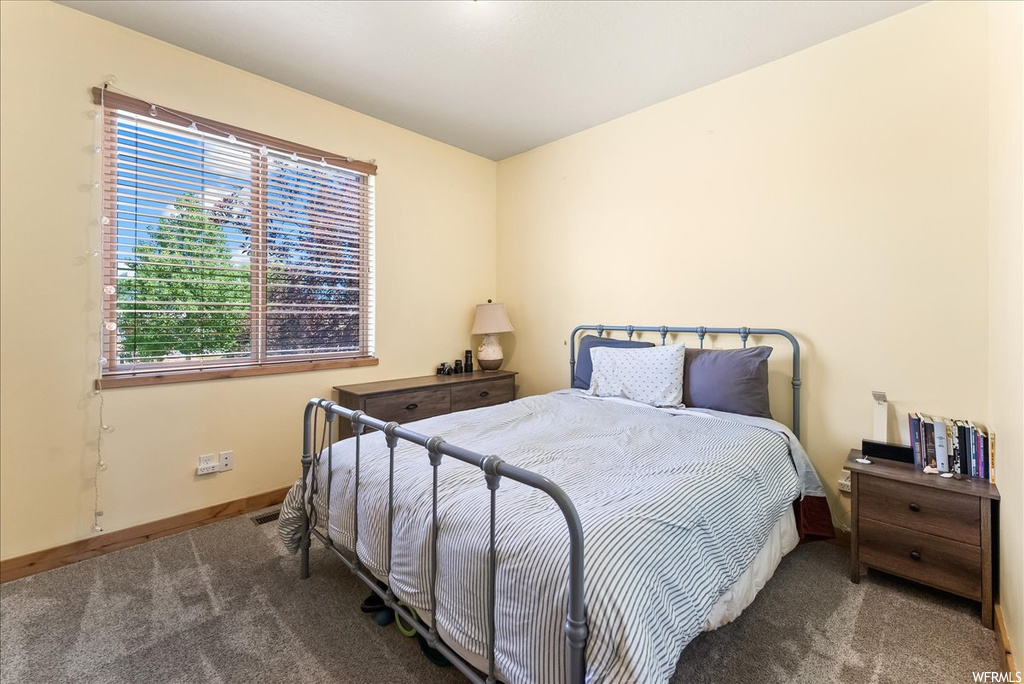 Bedroom featuring dark carpet