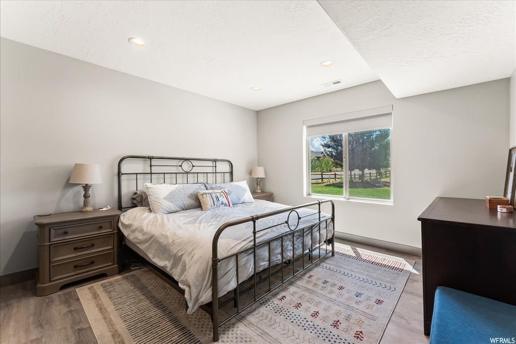 View of hardwood floored bedroom