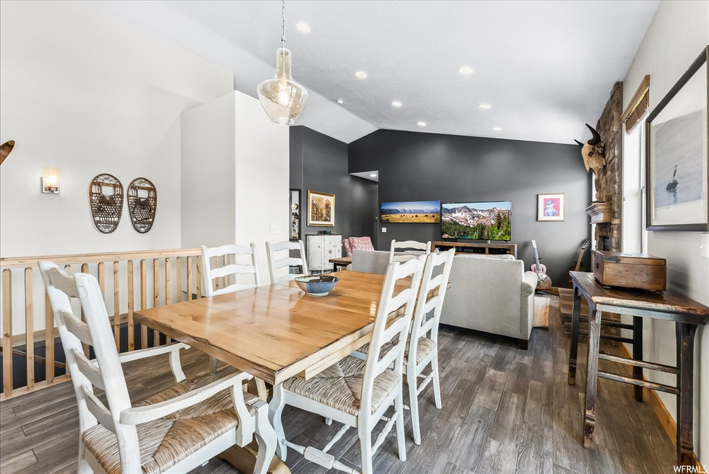 Dining room with hardwood flooring and vaulted ceiling