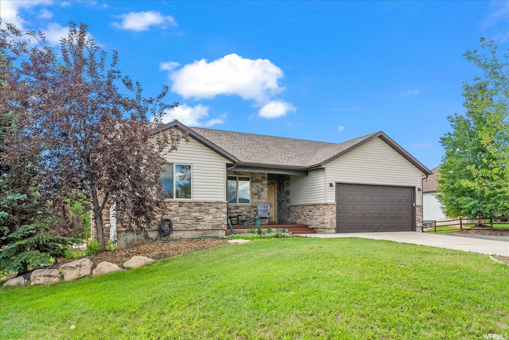 View of front of house with garage and a front yard