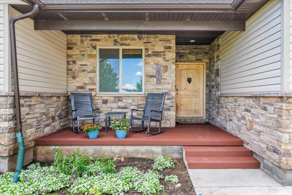 Entrance to property featuring a porch