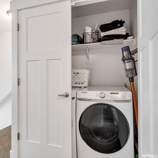Clothes washing area featuring washer / clothes dryer