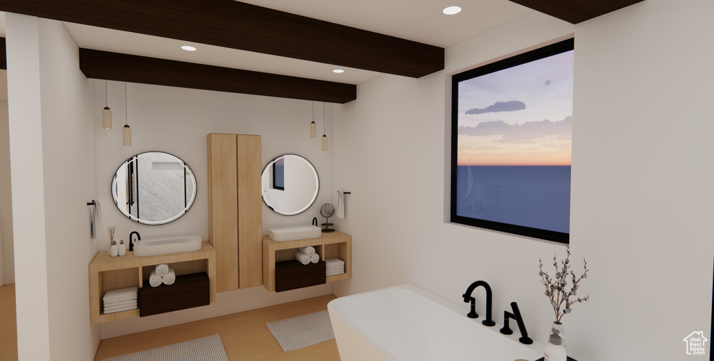 Bathroom featuring a bathing tub, hardwood / wood-style flooring, and dual bowl vanity