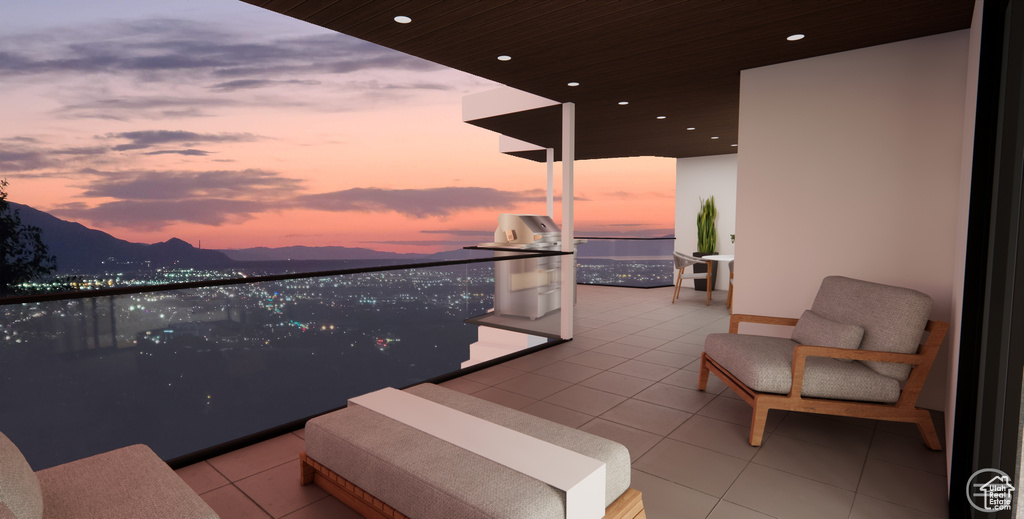 Balcony at dusk with grilling area and a mountain view