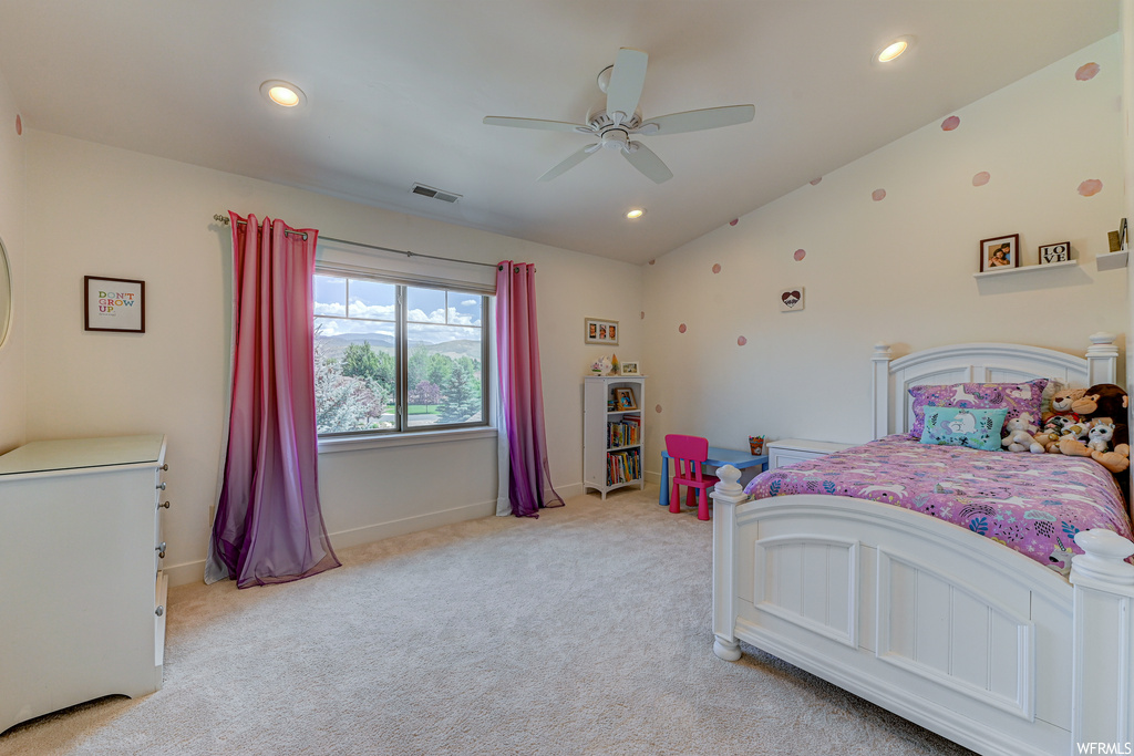 Bedroom featuring lofted ceiling, light carpet, and ceiling fan
