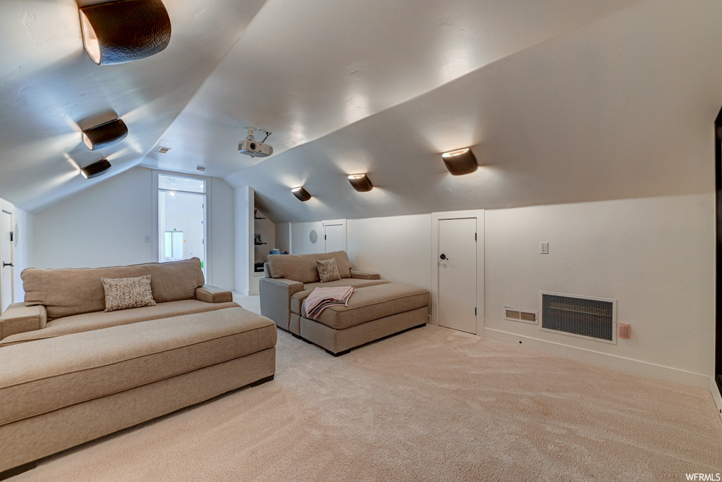 Carpeted cinema with vaulted ceiling