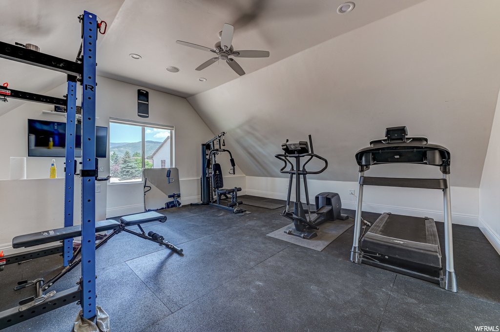 Exercise room featuring lofted ceiling and ceiling fan
