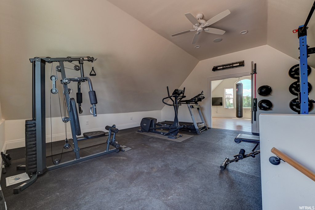 Exercise area with ceiling fan and vaulted ceiling
