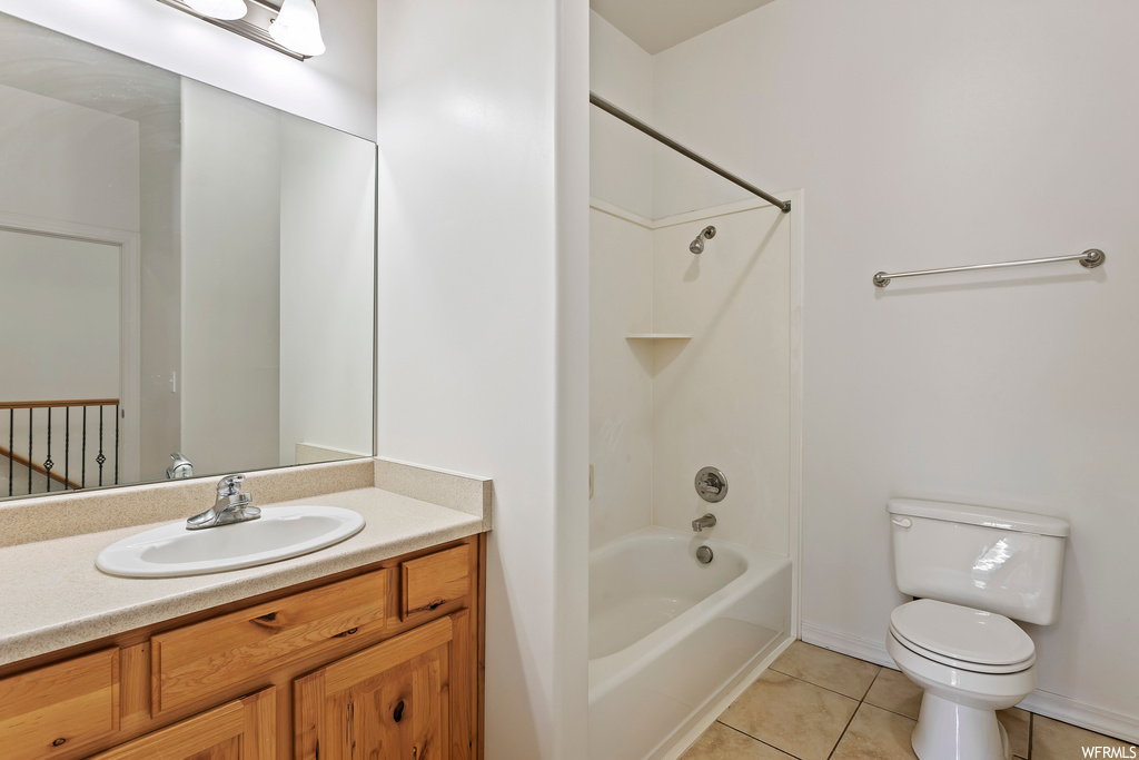 Full bathroom featuring shower / bathtub combination, oversized vanity, light tile flooring, and mirror
