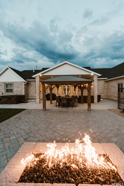View of home's community featuring a patio, a gazebo, and an outdoor firepit