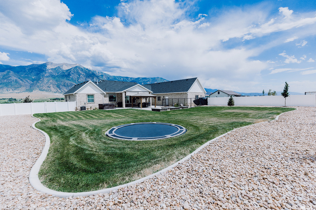 Exterior space with a front yard and a mountain view