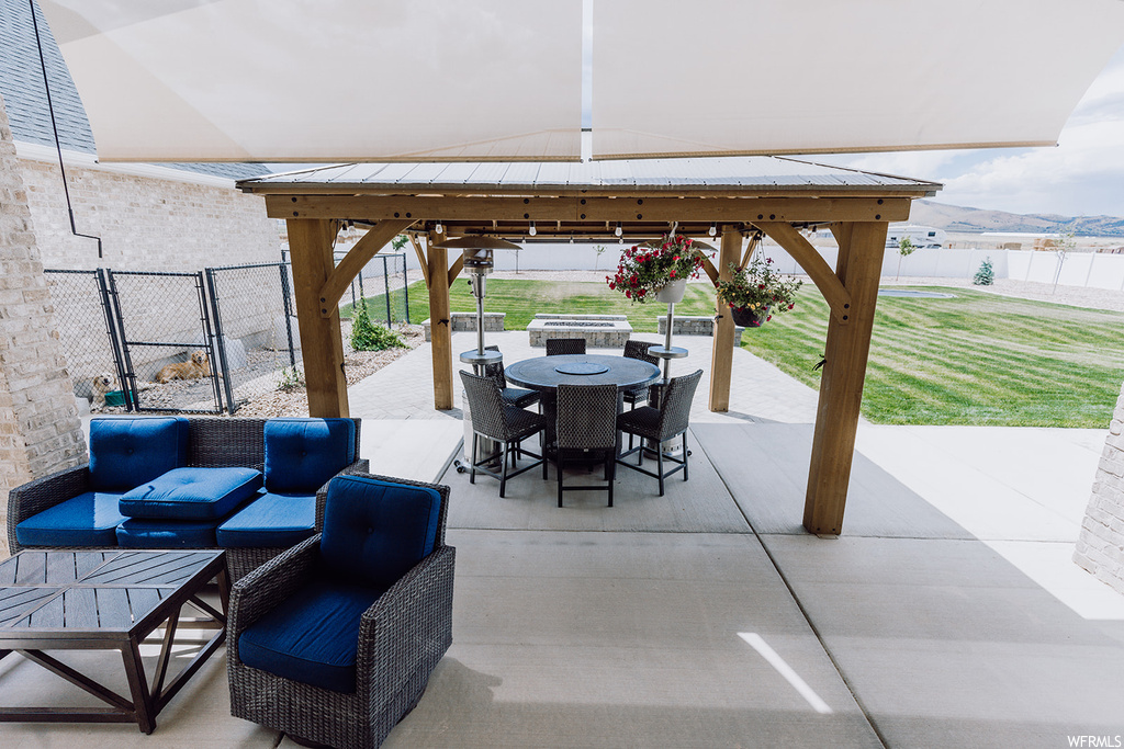 View of terrace featuring a gazebo, an outdoor living space, and a water view