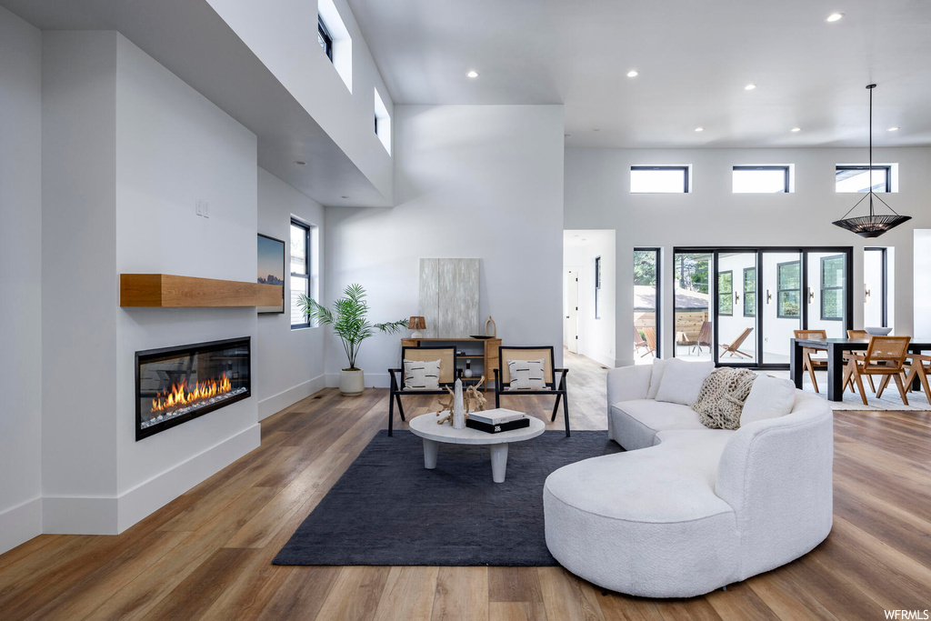 Living room with a high ceiling and light hardwood floors