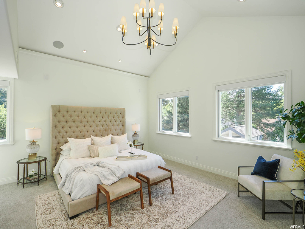Bedroom featuring light carpet, vaulted ceiling, and a high ceiling