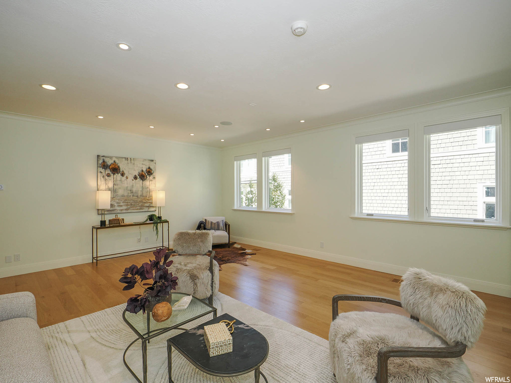 Hardwood floored living room with ornamental molding