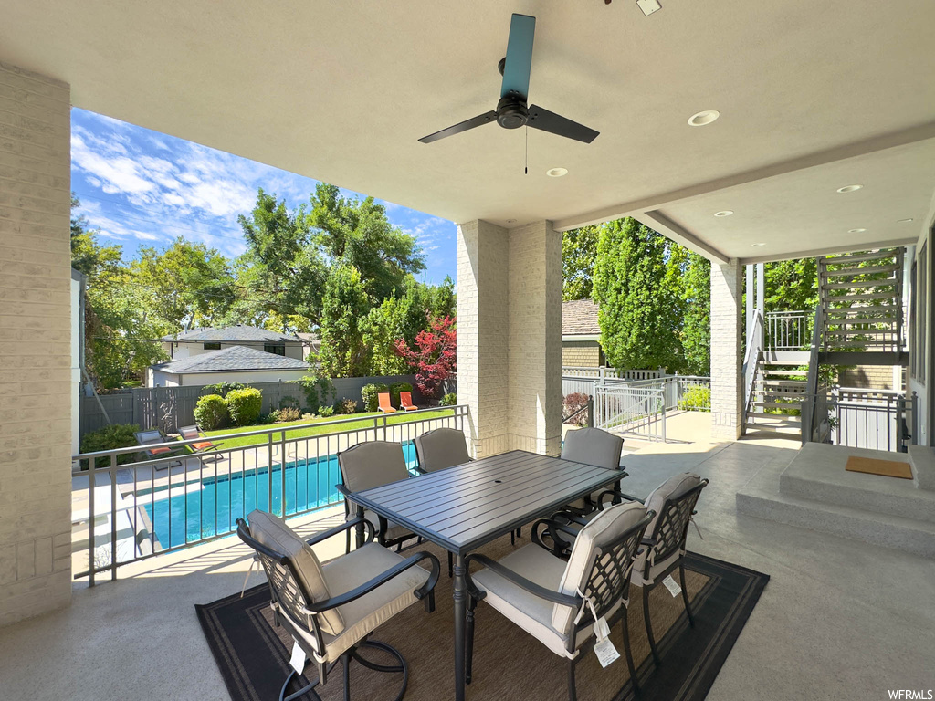 View of patio featuring pool and ceiling fan