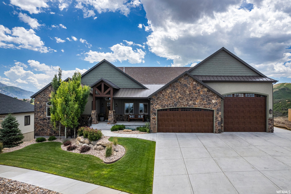 View of front of house with garage and a front yard