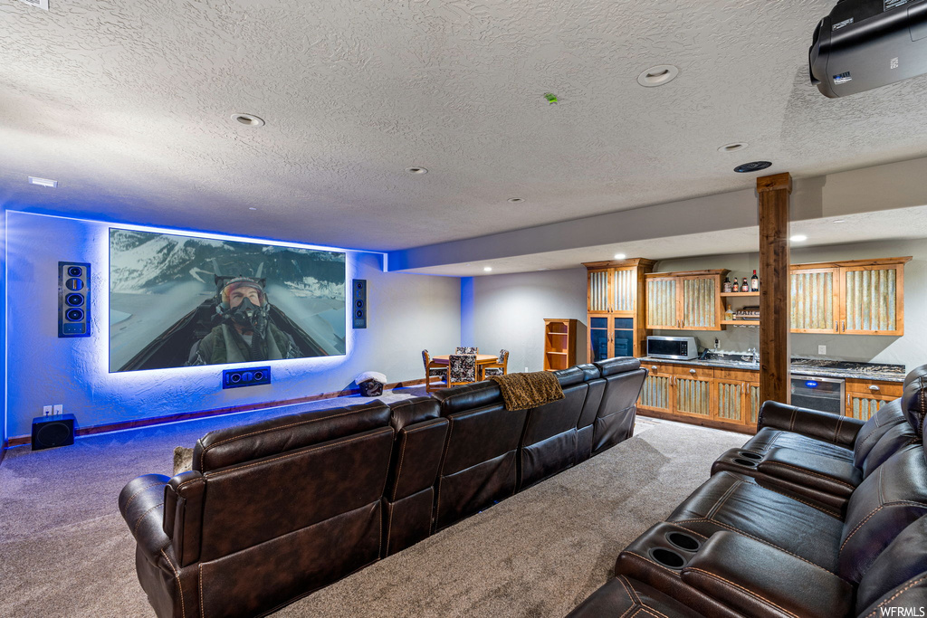 Carpeted cinema featuring a textured ceiling