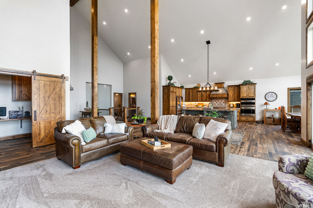Living room featuring a high ceiling, vaulted ceiling, and light carpet