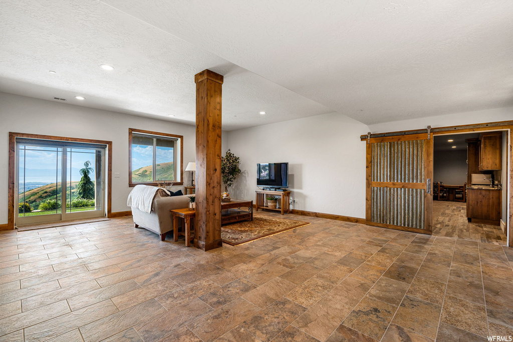 Living room featuring a textured ceiling and light tile floors
