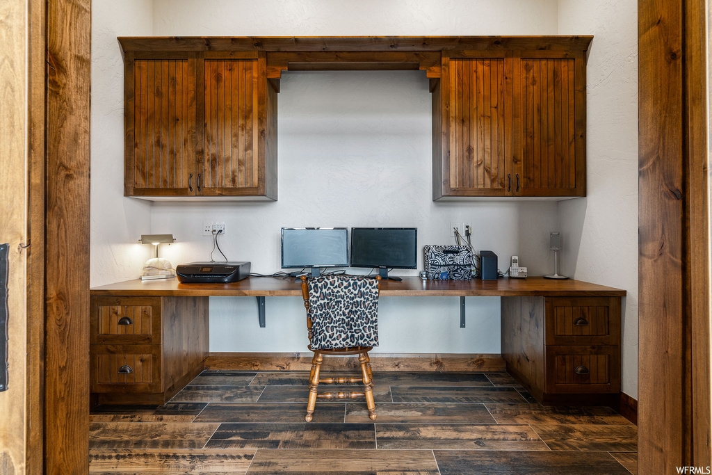 Home office featuring dark hardwood floors
