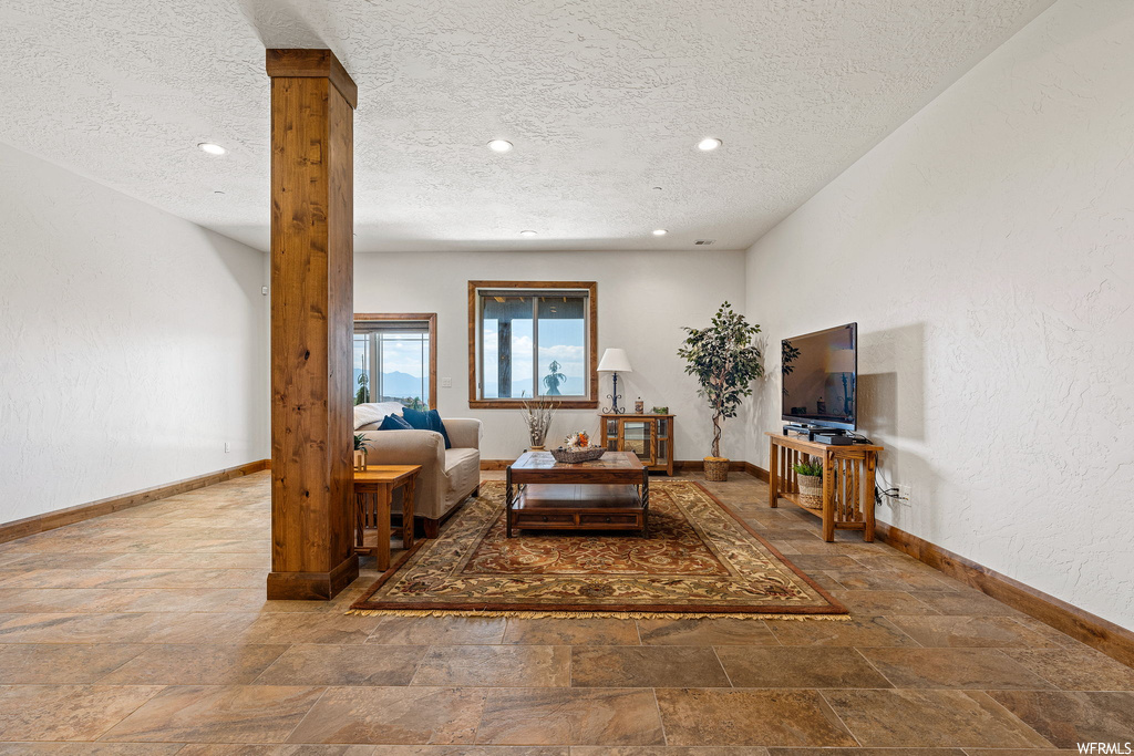 Tiled living room with a textured ceiling