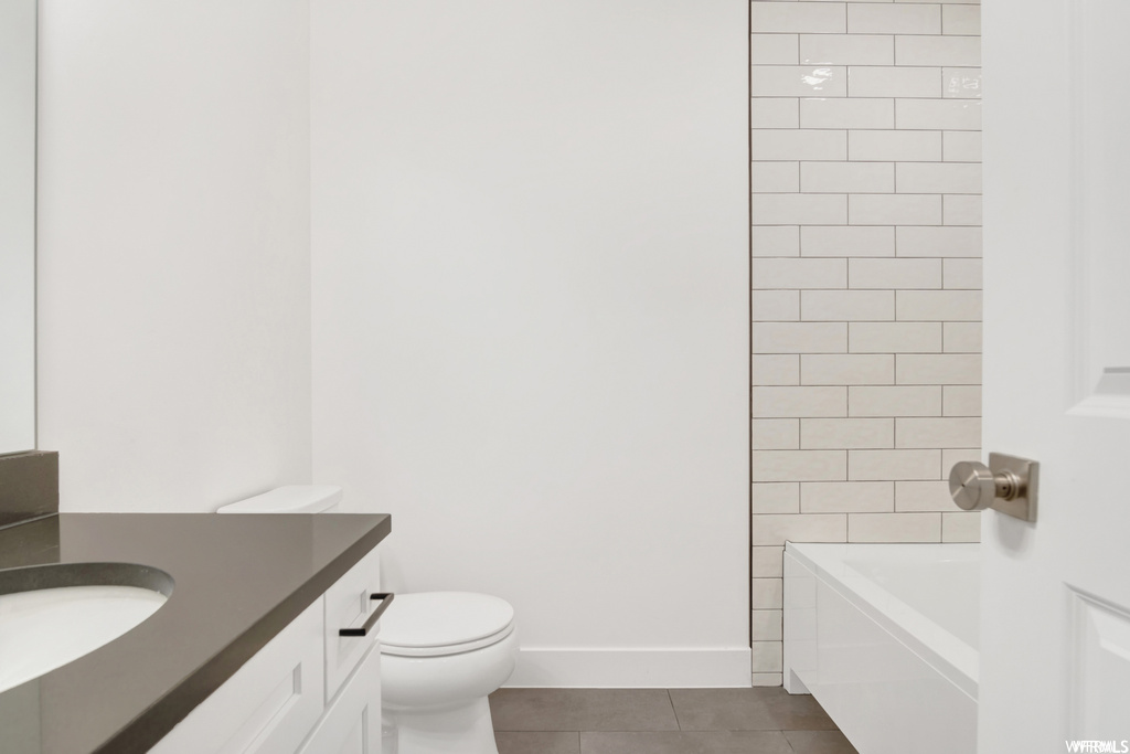Full bathroom with vanity, tile floors, and tiled shower / bath combo