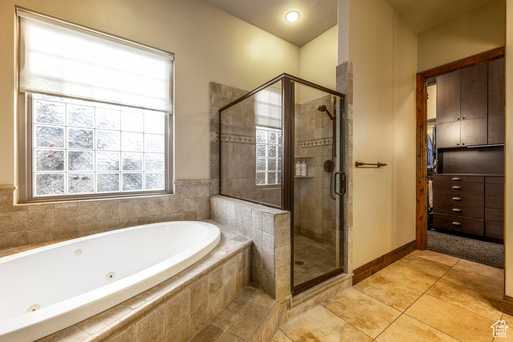 Bathroom with tile floors and plus walk in shower
