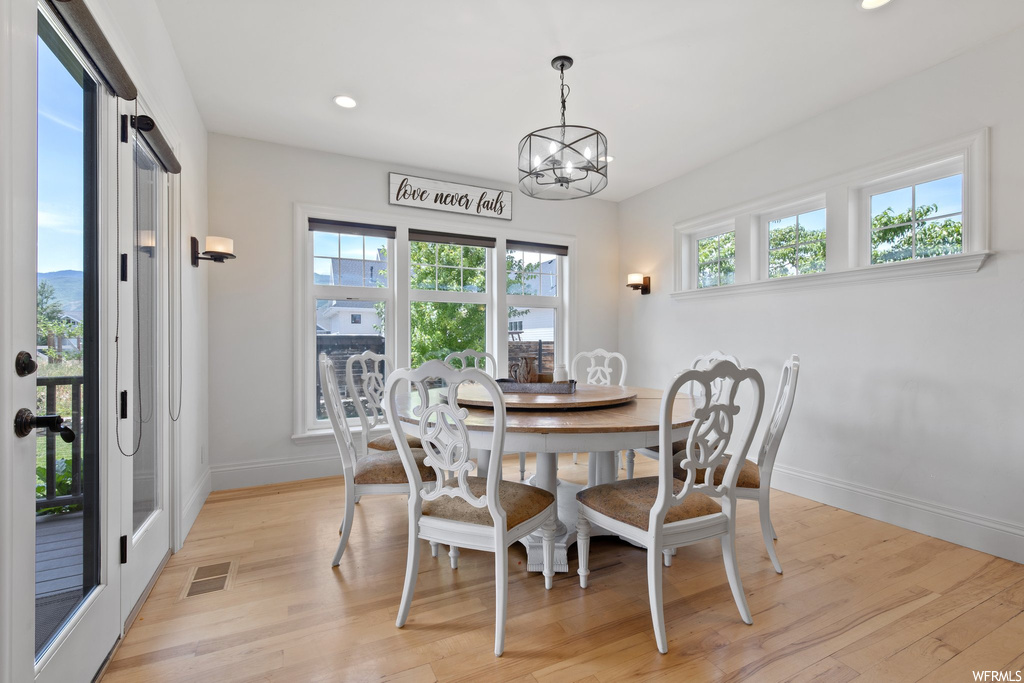 Dining room with light parquet floors and a wealth of natural light