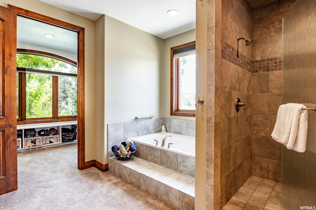 Bathroom featuring separate shower and tub enclosures