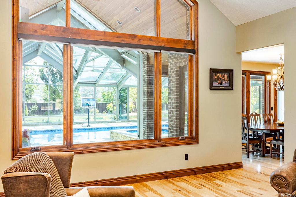 Interior space featuring vaulted ceiling, light hardwood flooring, and a high ceiling