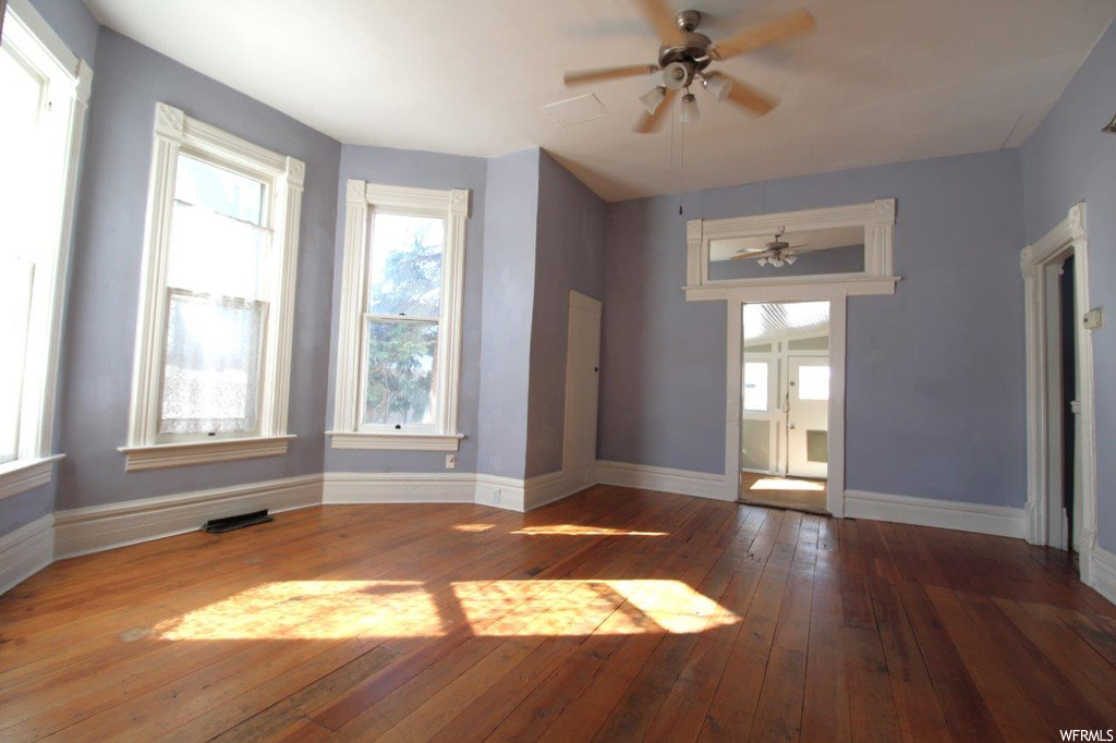 Wood floored spare room with ceiling fan