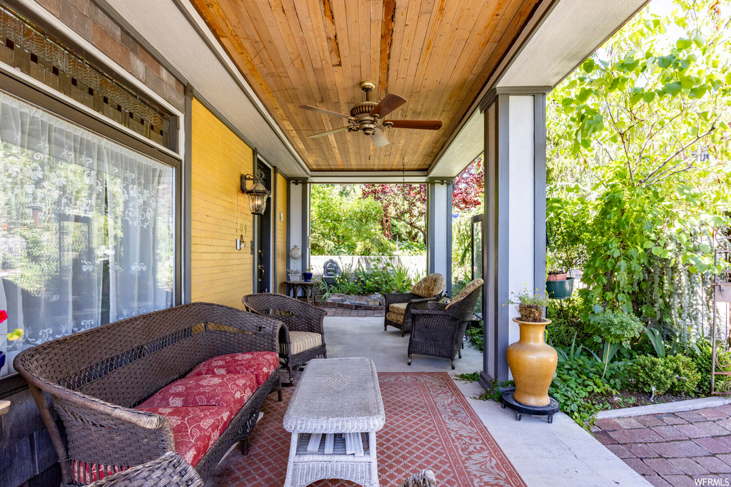 View of terrace featuring ceiling fan and an outdoor living space
