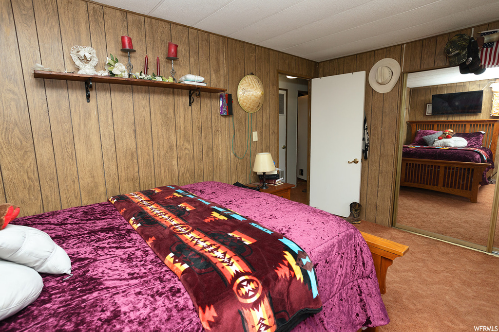Carpeted bedroom with wooden walls