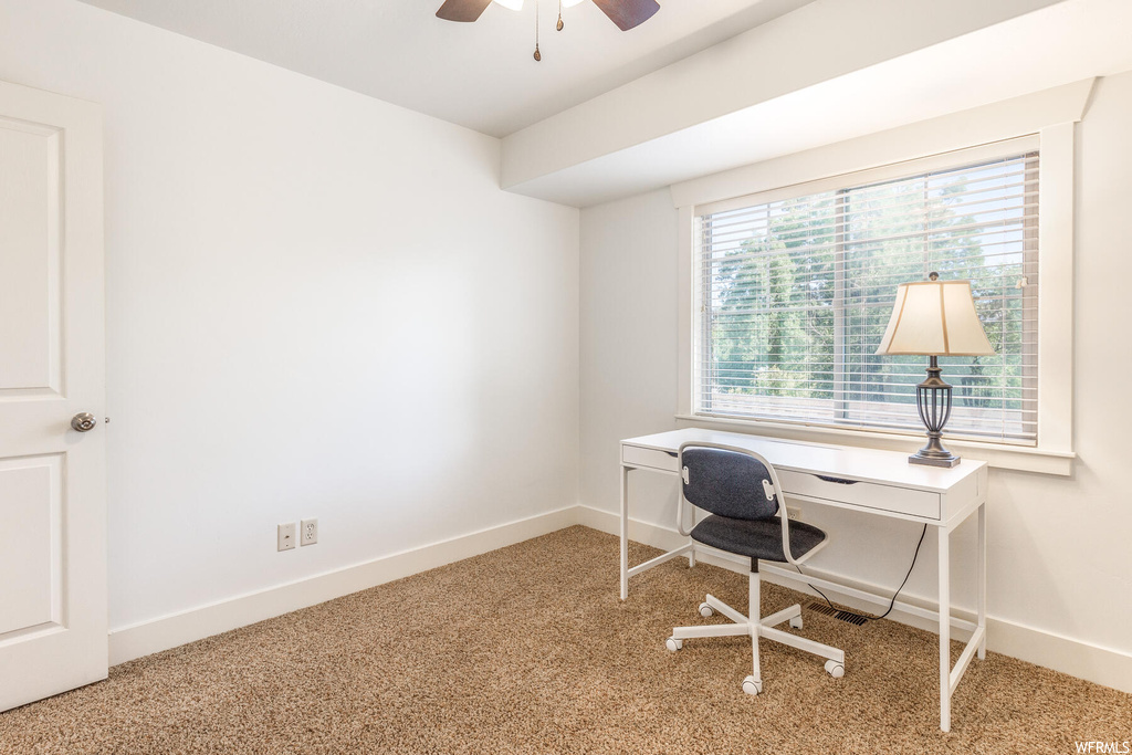 Office space featuring ceiling fan and light carpet