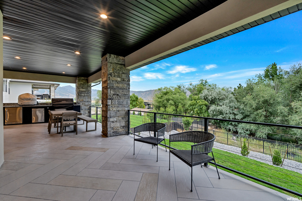 View of patio featuring an outdoor living space and an outdoor kitchen