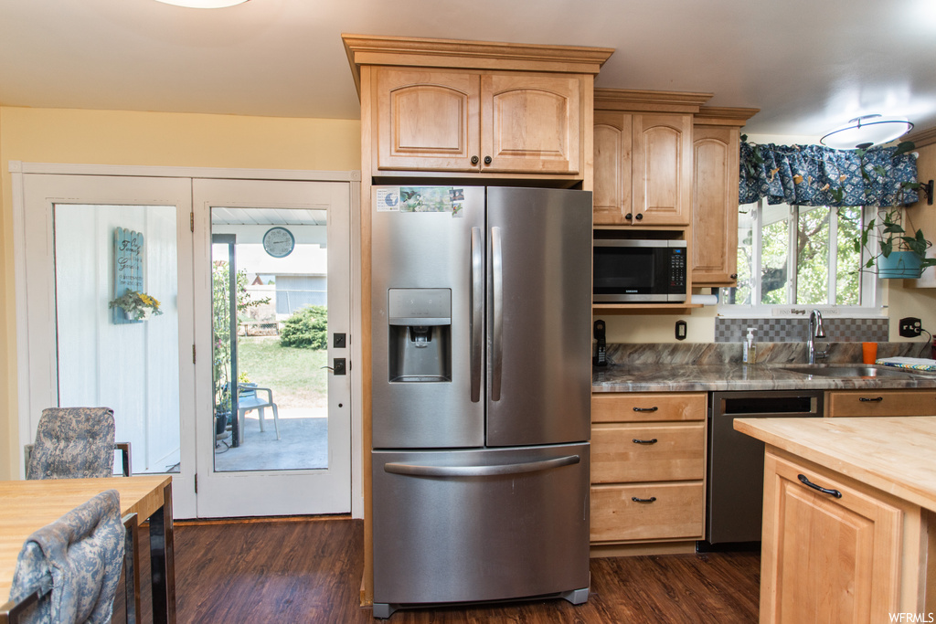 Kitchen featuring dark hardwood floors and stainless steel appliances