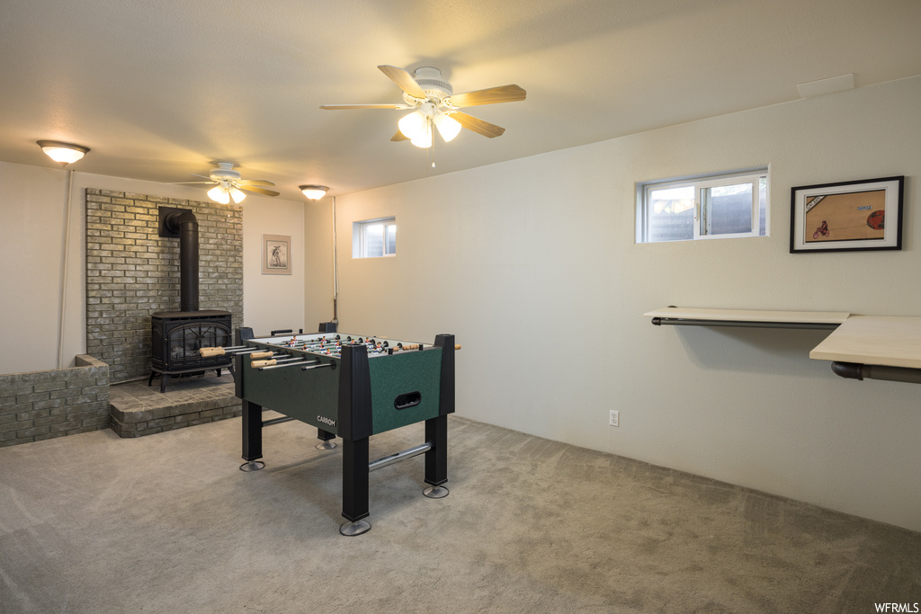 Rec room with light carpet, ceiling fan, and a wealth of natural light