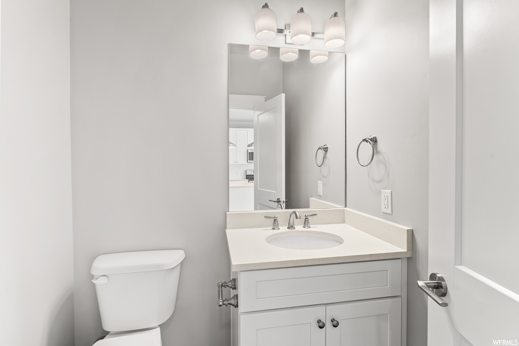 Bathroom with vanity with extensive cabinet space and mirror