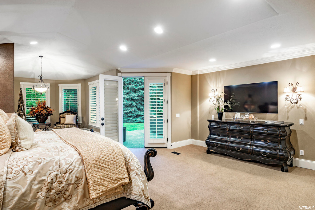 Carpeted bedroom featuring crown molding
