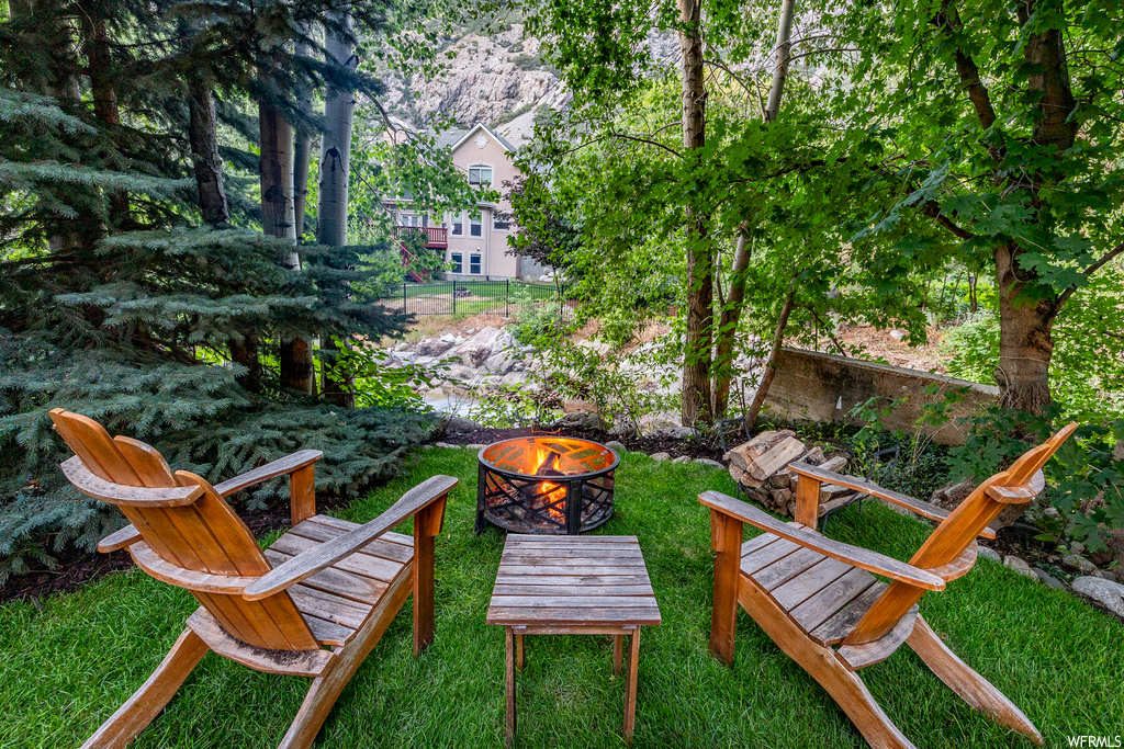 View of yard with an outdoor firepit