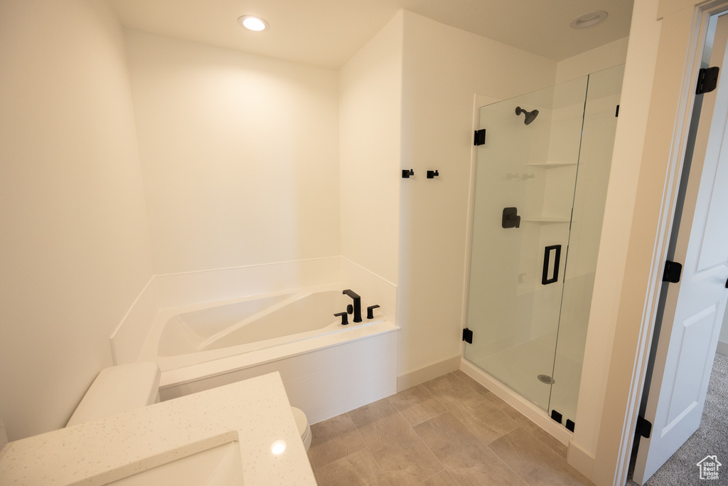 Bathroom with separate shower and tub and tile flooring