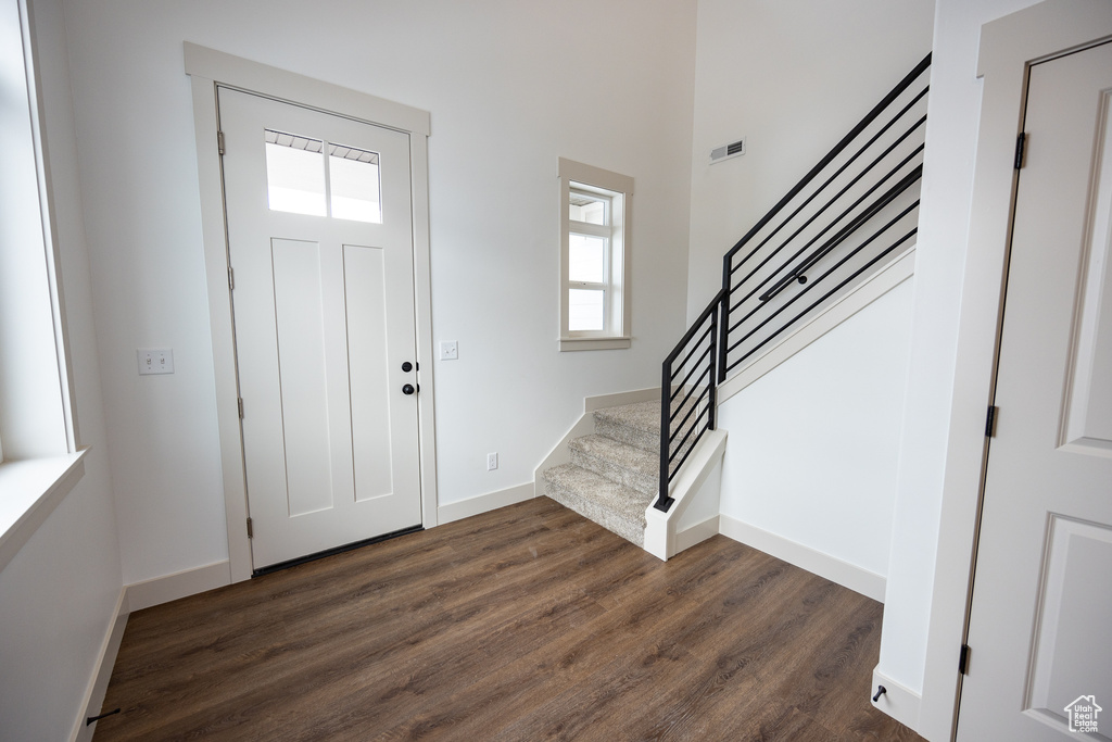 Foyer entrance with dark hardwood / wood-style floors