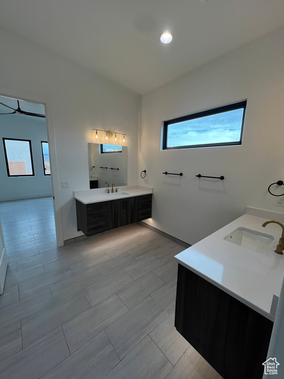 Bathroom featuring plenty of natural light, tile floors, and vanity