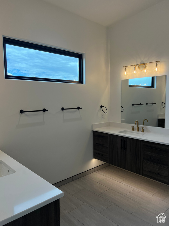 Bathroom featuring vanity, plenty of natural light, and tile flooring