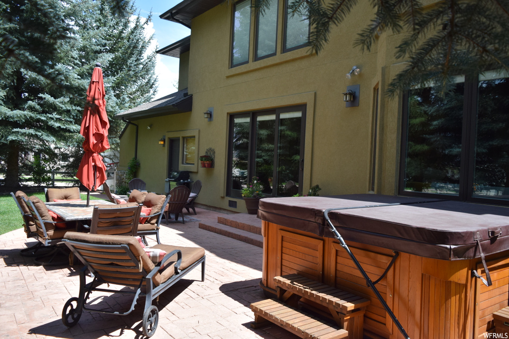 View of patio featuring hot tub