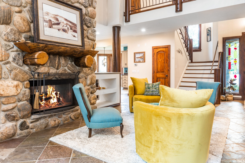 Tiled living room featuring plenty of natural light and a fireplace