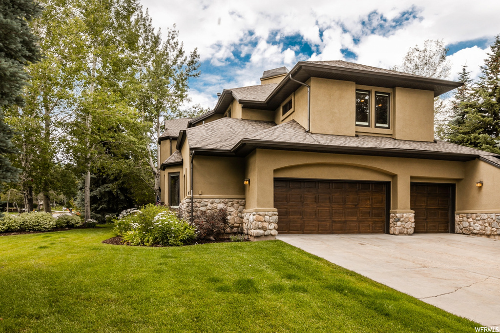 Prairie-style home with a front lawn and garage