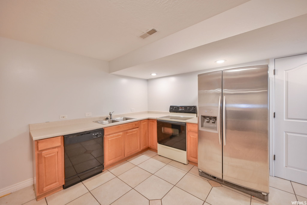 Kitchen with light tile floors, black dishwasher, high end refrigerator, light countertops, and white electric stove