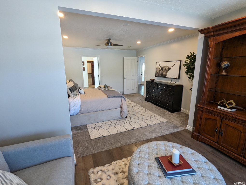 Bedroom with ceiling fan and light hardwood flooring